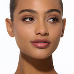 Close-up of a woman's face with neutral background