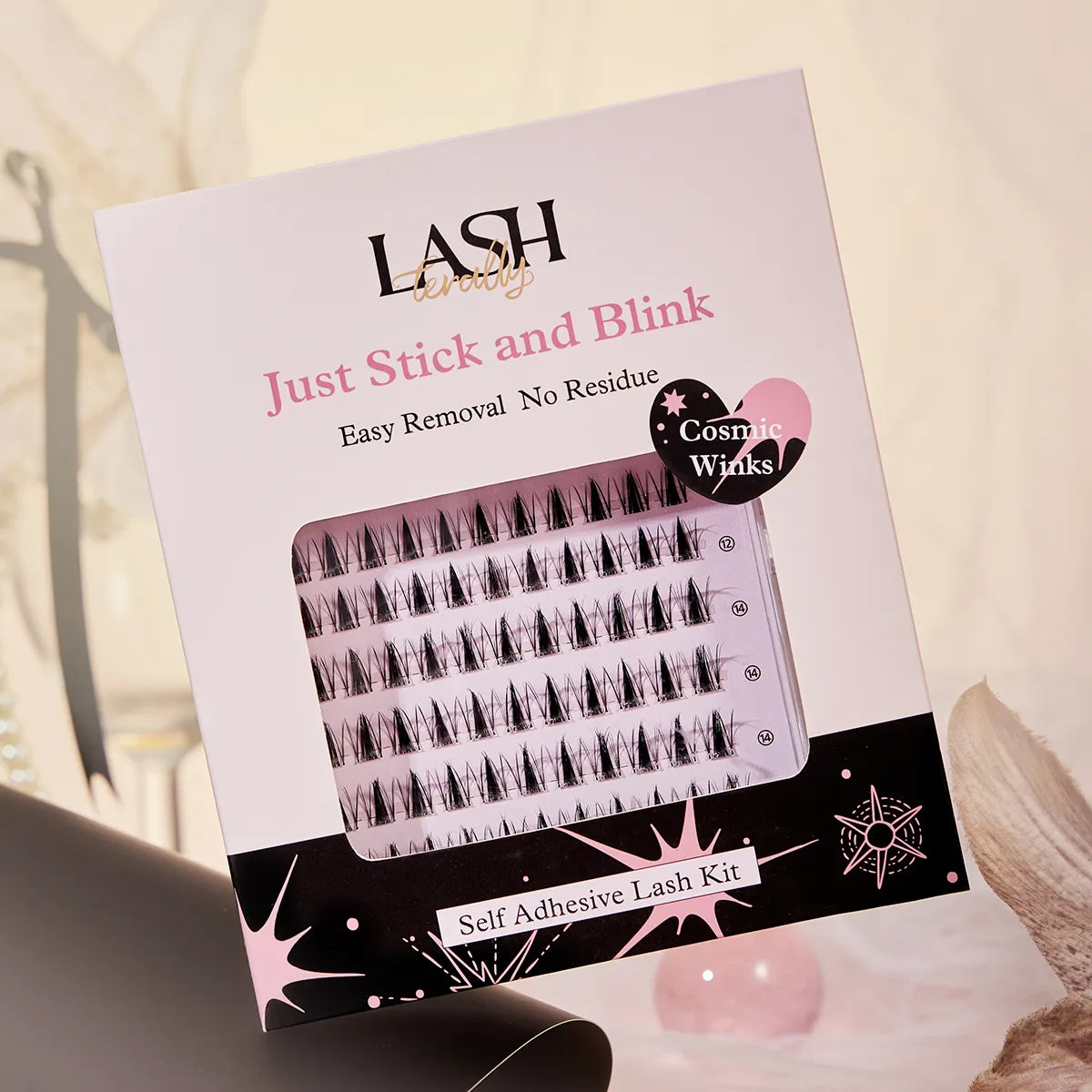 Cosmetic Winks self-adhesive lash kit packaging on a blurred background