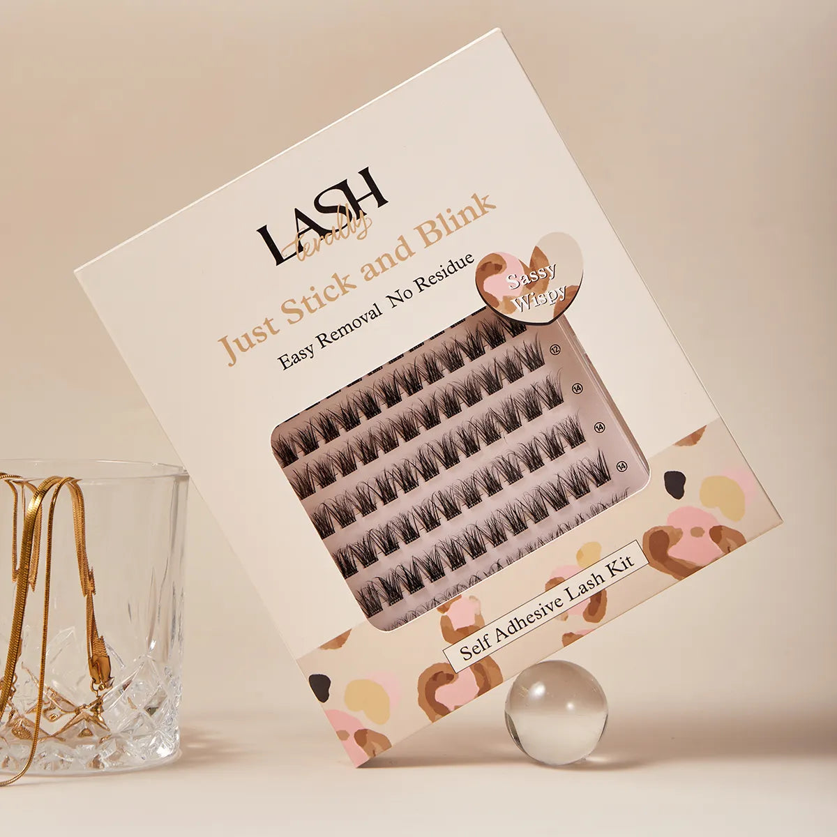 Box of self-adhesive false eyelashes with decorative design on a neutral background